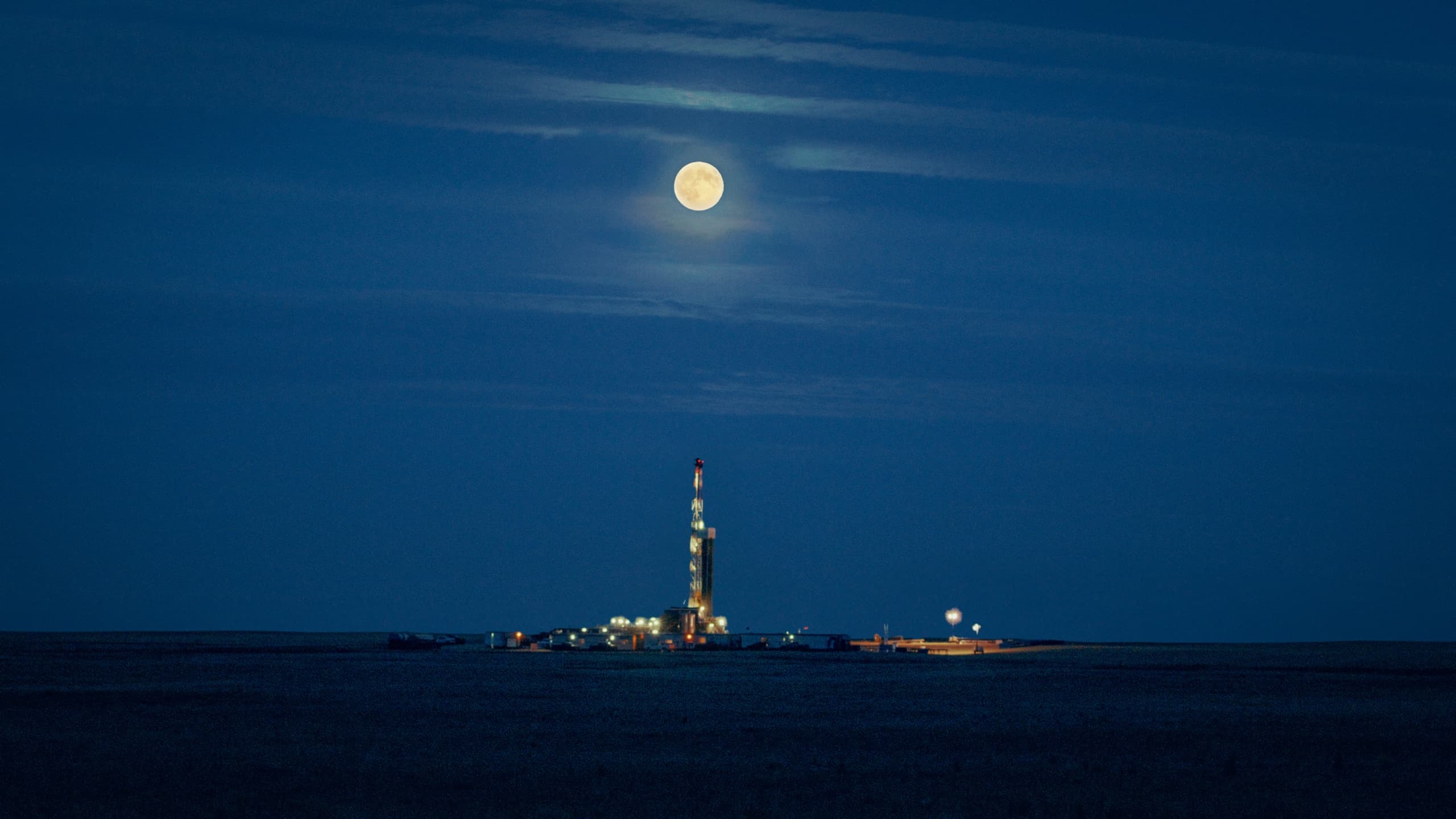 MAX Power drill rig at night under a full moon